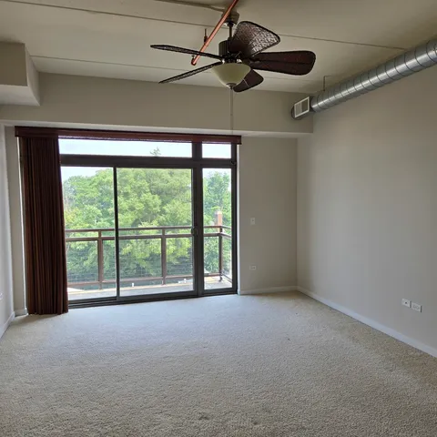 a view of room with a ceiling fan