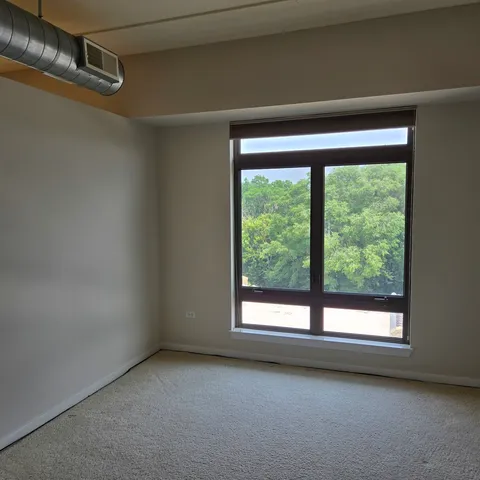 a view of room with window and ceiling fan