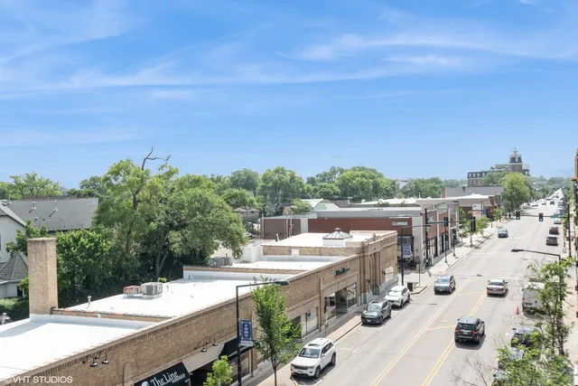 a view of a terrace with chairs and wooden fence