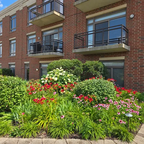 a house with a flower garden in front of it