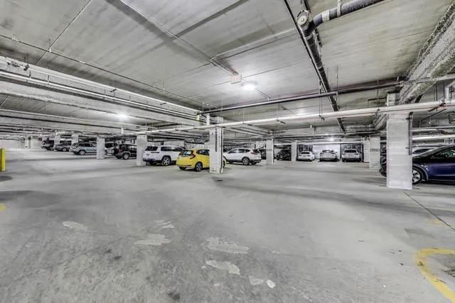 a view of parking garage with cars