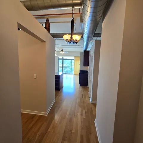 a view of a hallway view with wooden floor and staircase