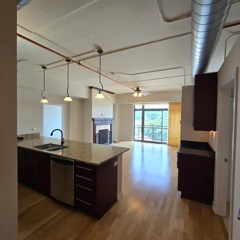 a kitchen with sink cabinets and wooden floor