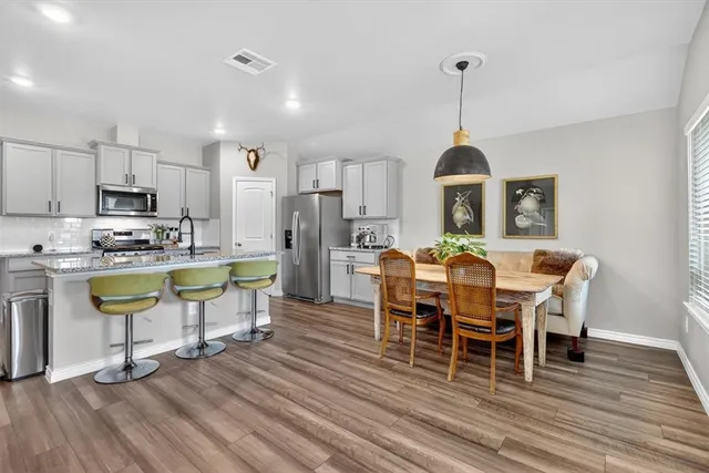 a view of a dining room with furniture window and wooden floor