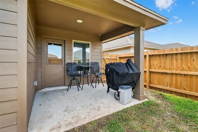 a view of a chairs and table in patio