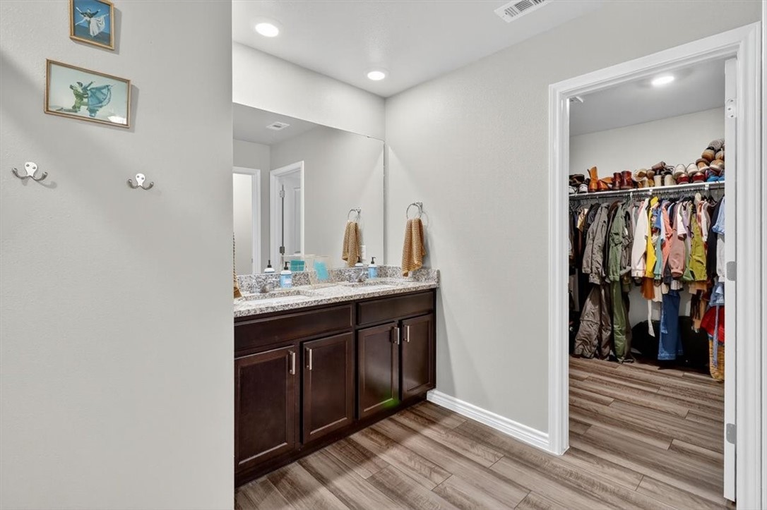 1126 Carnaby Street Corpus Christi, TX 78415 - Photo 24 of 39 a bathroom with a double vanity sink and a mirror