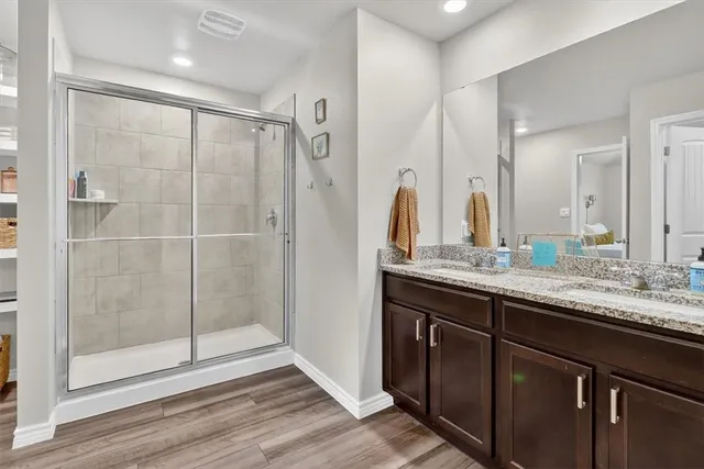 a bathroom with a shower sink and mirror