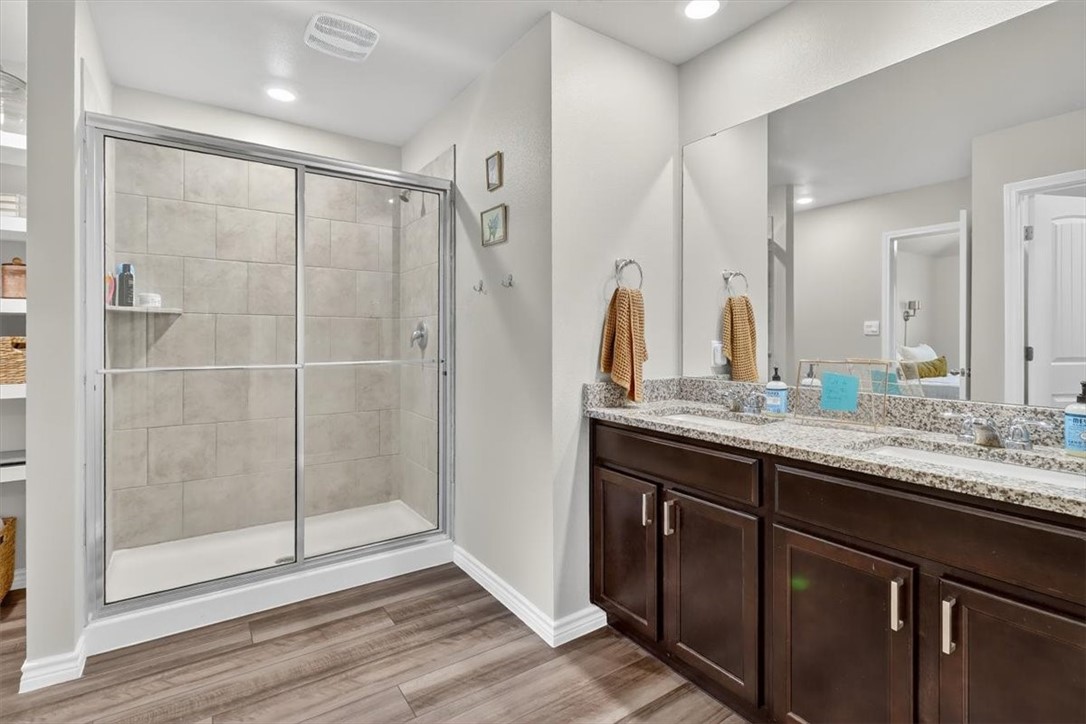 1126 Carnaby Street Corpus Christi, TX 78415 - Photo 25 of 39 a bathroom with a shower sink and mirror