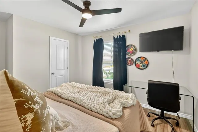 a bedroom with a bed and a flat screen tv