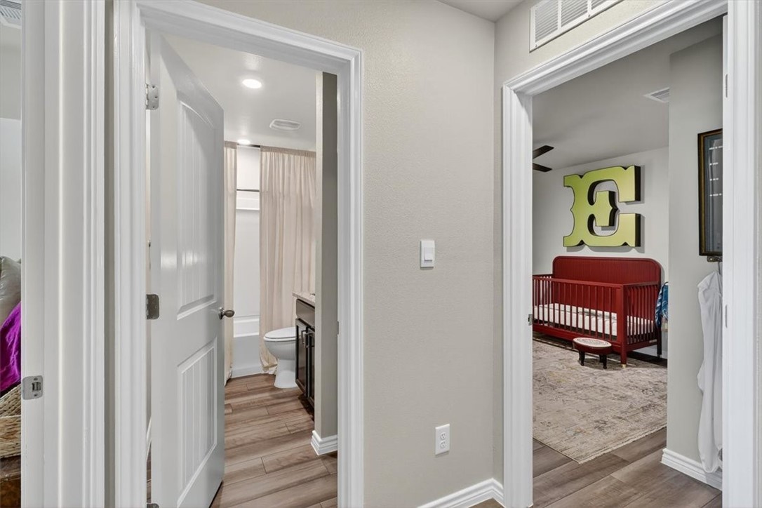 1126 Carnaby Street Corpus Christi, TX 78415 - Photo 28 of 39 a view of a bedroom with a bed and wooden floor
