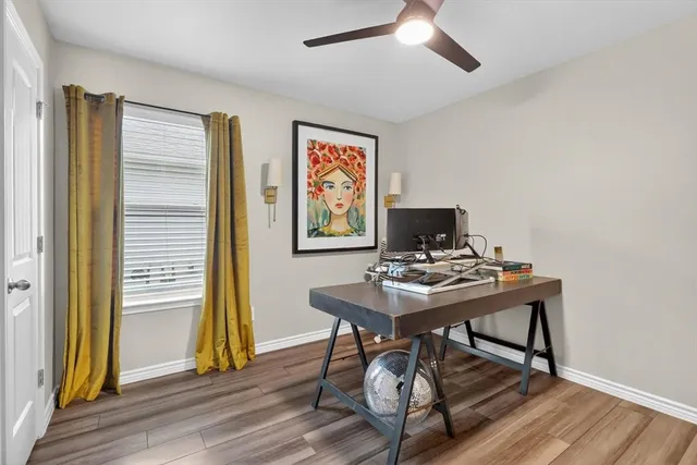 a view of a workspace with furniture and wooden floor