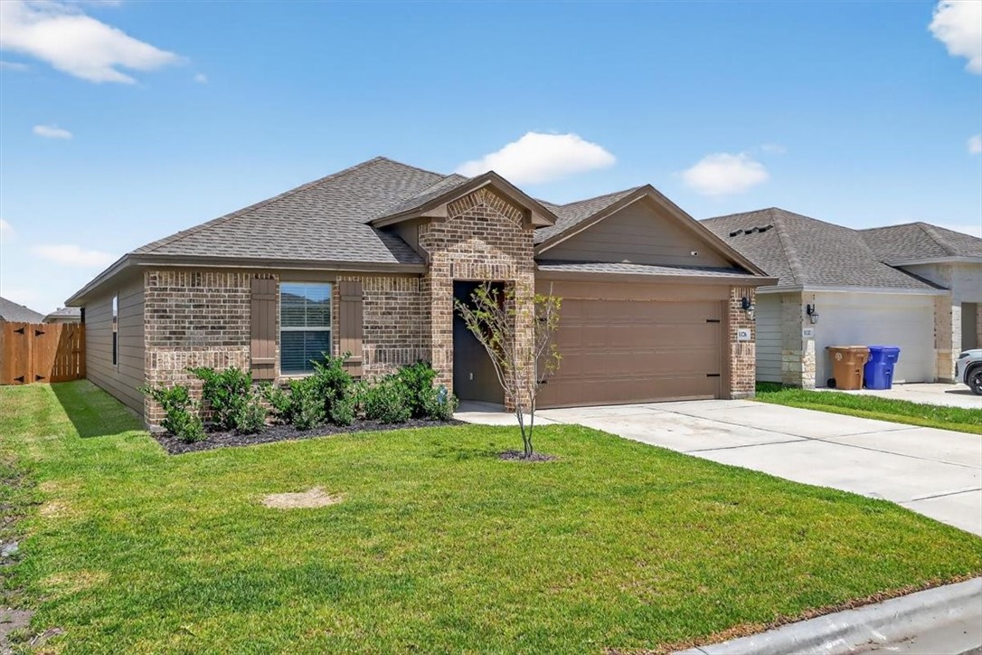 1126 Carnaby Street Corpus Christi, TX 78415 - Photo 39 of 39 a front view of a house with a yard and garage