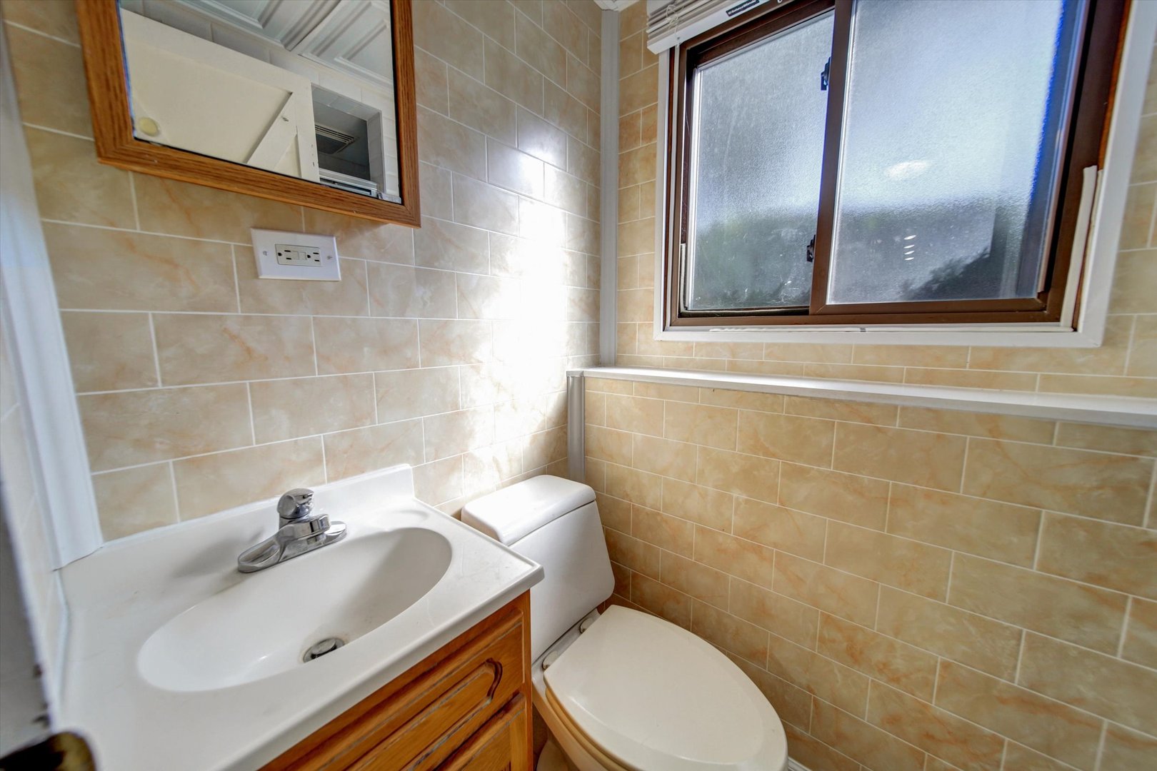 445 South Yale Avenue Addison, IL 60101 - Photo 16 of 20 a bathroom with a sink a mirror and a toilet