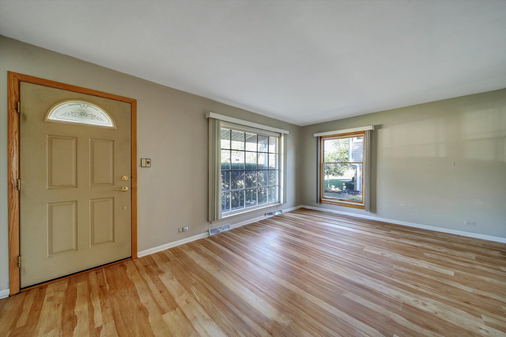 445 South Yale Avenue Addison, IL 60101 - Photo 3 of 20 a view of an empty room with wooden floor and a window