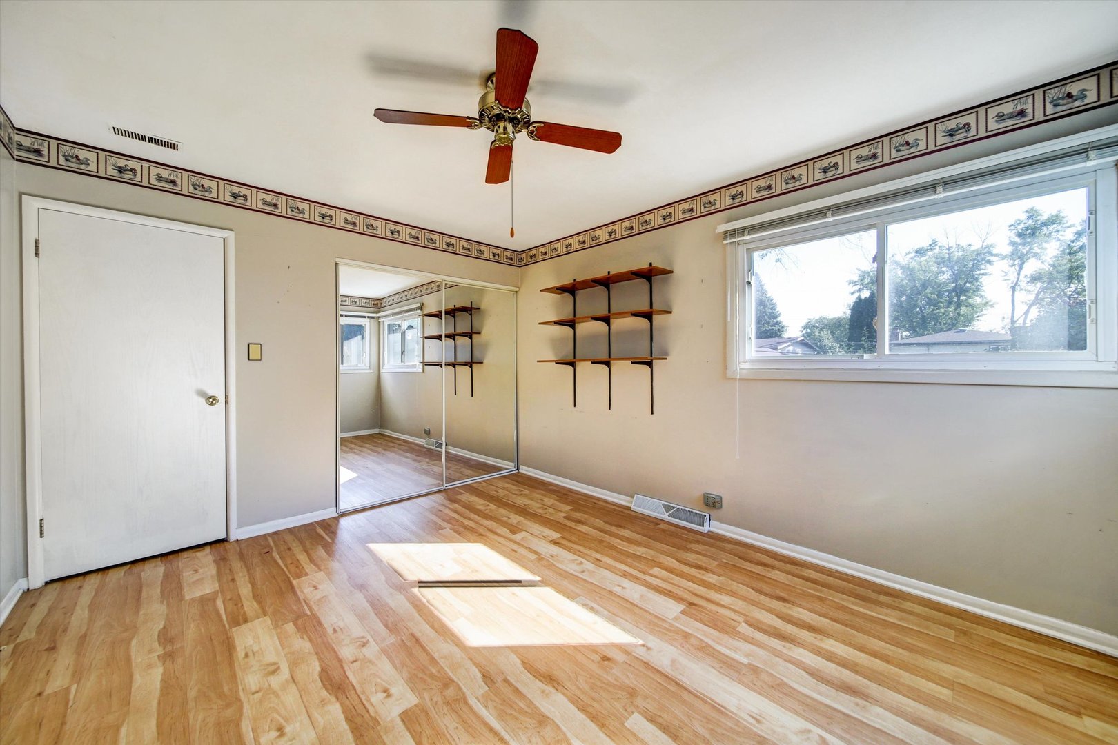 445 South Yale Avenue Addison, IL 60101 - Photo 9 of 20 a view of empty room with wooden floor and fan