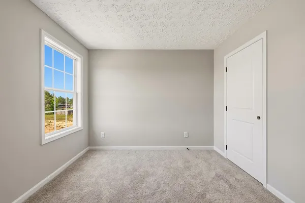an empty room with yellow walls and ceiling fan