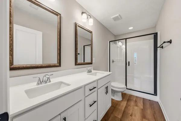 a bathroom with a shower a toilet and a sink