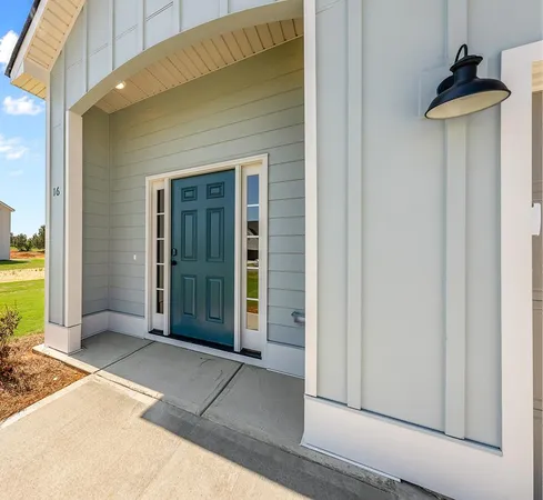 a view of white house with a yard