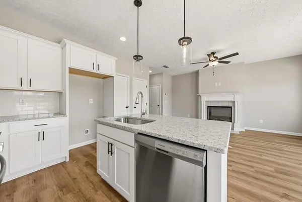 a kitchen with stainless steel appliances granite countertop a stove a microwave and a hard wood floors