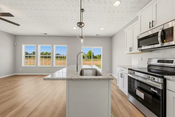 a view of an empty room with a window and a fireplace
