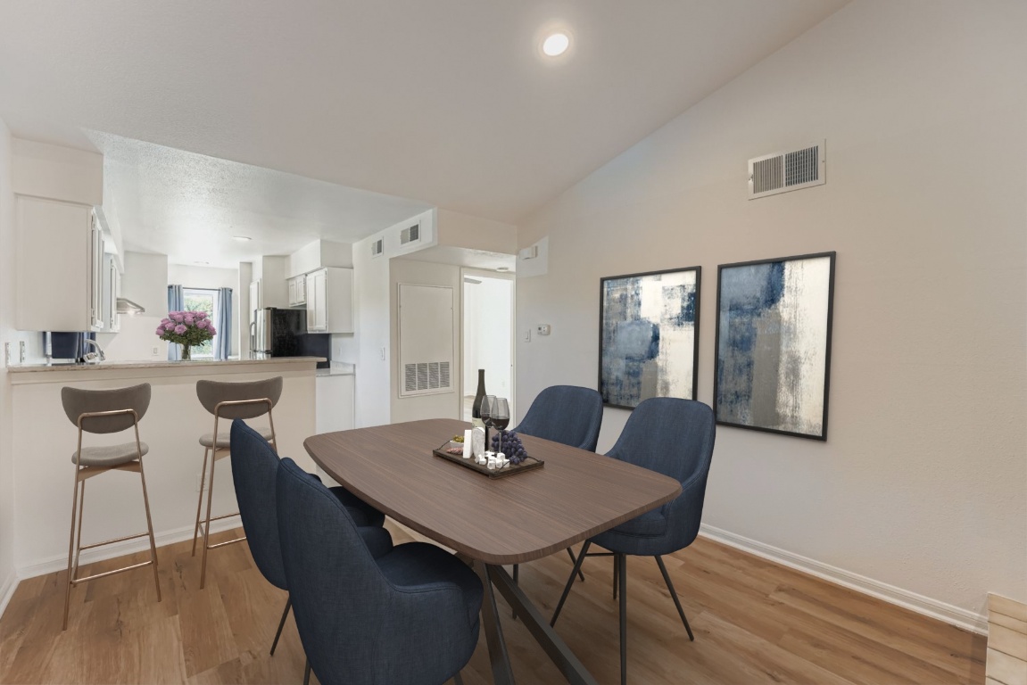 2450 Wickersham Lane, Unit 604 Austin, TX 78741 - Photo 11 of 22 a view of a dining room with furniture and wooden floor