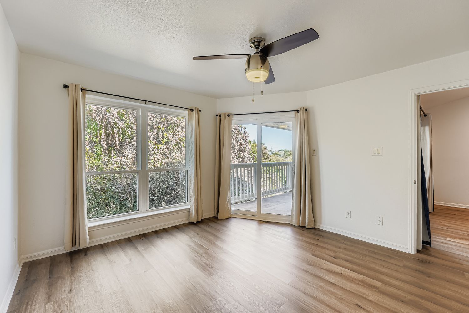 2450 Wickersham Lane, Unit 604 Austin, TX 78741 - Photo 14 of 22 a view of an empty room with wooden floor and a window