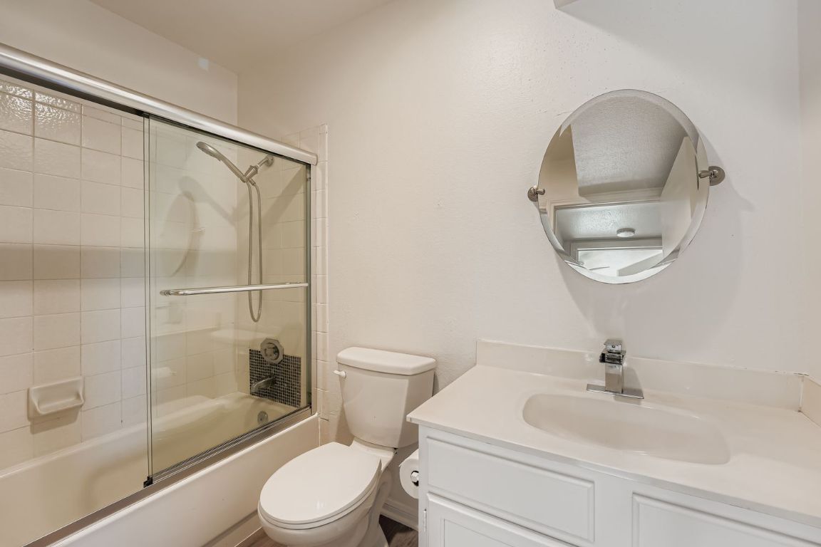 2450 Wickersham Lane, Unit 604 Austin, TX 78741 - Photo 19 of 22 a bathroom with a sink toilet and shower