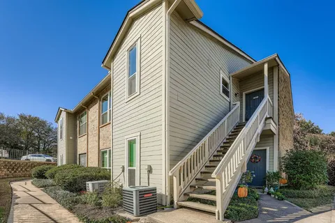 a view of a house with stairs and wooden stairs