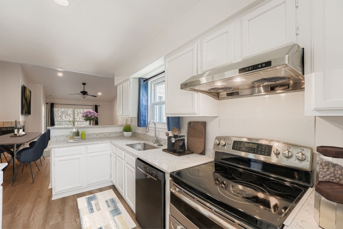 2450 Wickersham Lane, Unit 604 Austin, TX 78741 - Photo 6 of 22 a kitchen with a stove and a sink