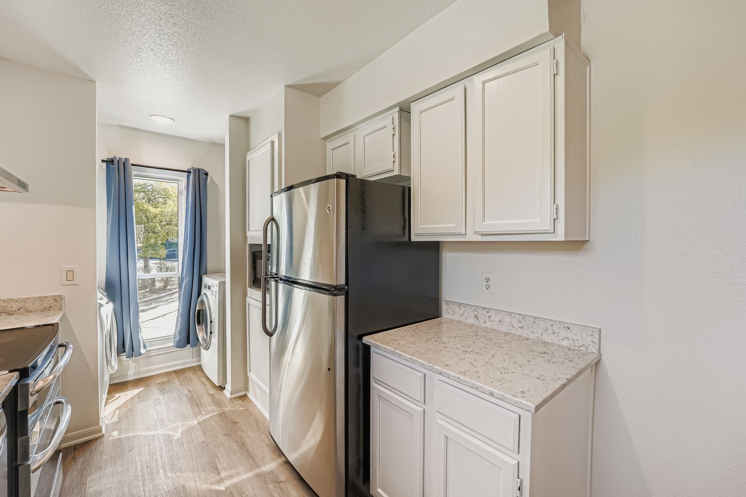 2450 Wickersham Lane, Unit 604 Austin, TX 78741 - Photo 9 of 22 a kitchen with a refrigerator sink and cabinets