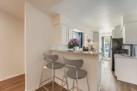 a view of a dining room with furniture and wooden floor