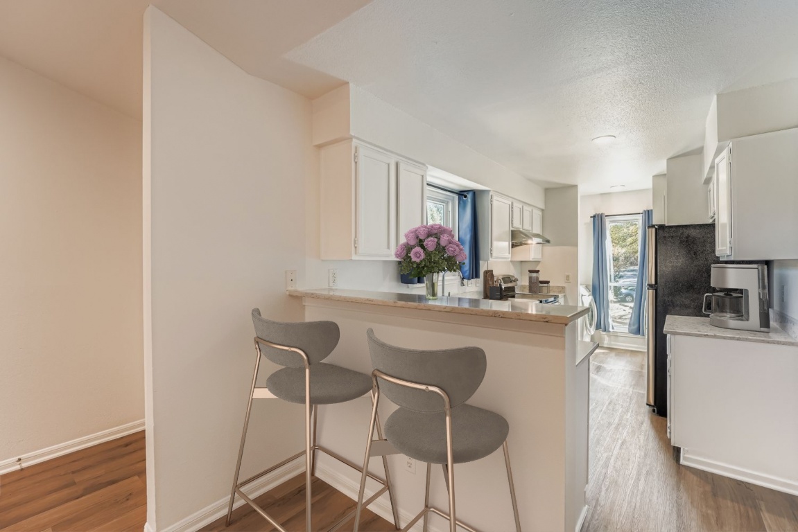 2450 Wickersham Lane, Unit 604 Austin, TX 78741 - Photo 10 of 22 a kitchen with stainless steel appliances a refrigerator and a stove top oven
