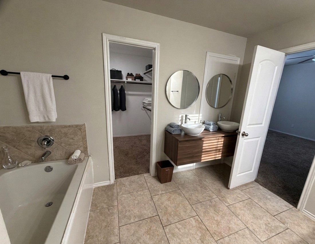 24307 Hampton Terrace Lane Spring, TX 77389 - Photo 10 of 20 Experience luxury in this virtually staged primary bath featuring a sleek double vanity, elegant tile flooring, and a spacious tub.