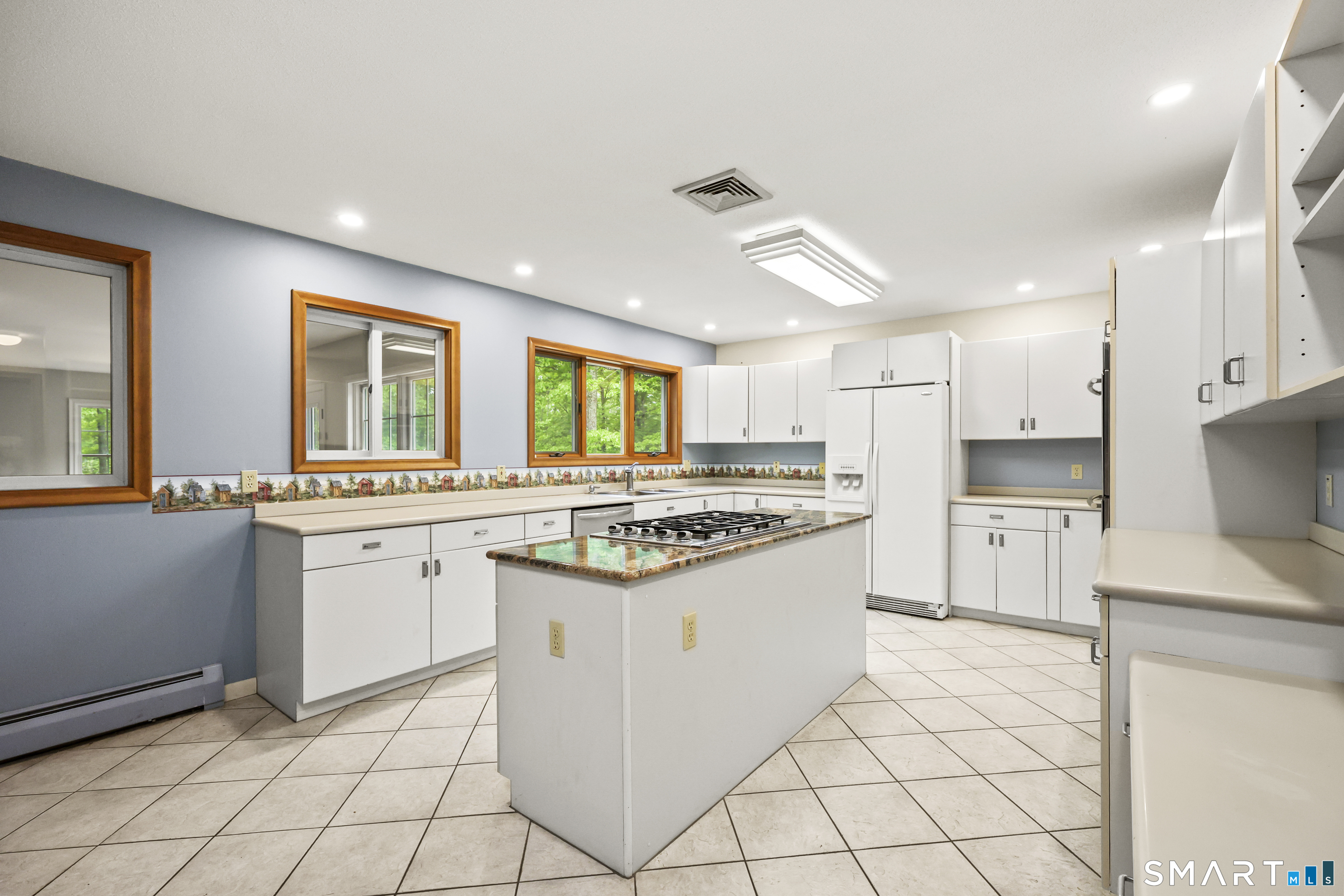96 Spak Road Willington, CT 06279 - Photo 11 of 40 The kitchen is designed for both function & gatherings, featuring center island with gas cooktop & granite countertop, & double ovens.
