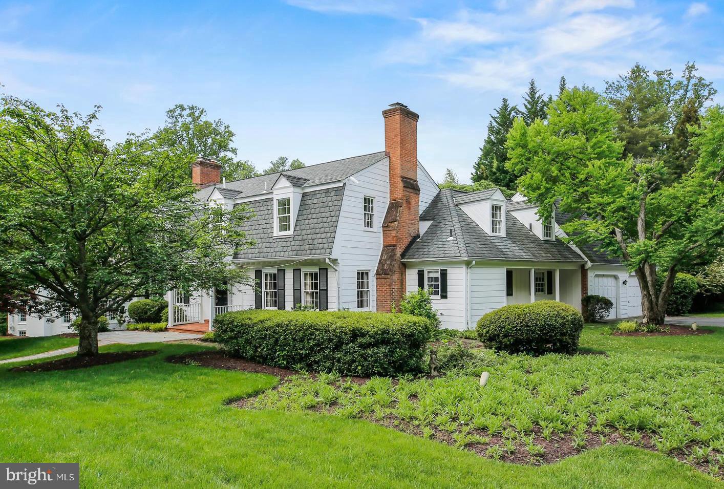 7125 Darby Road Bethesda, MD 20817 - Photo 1 of 64 a front view of a house with a garden