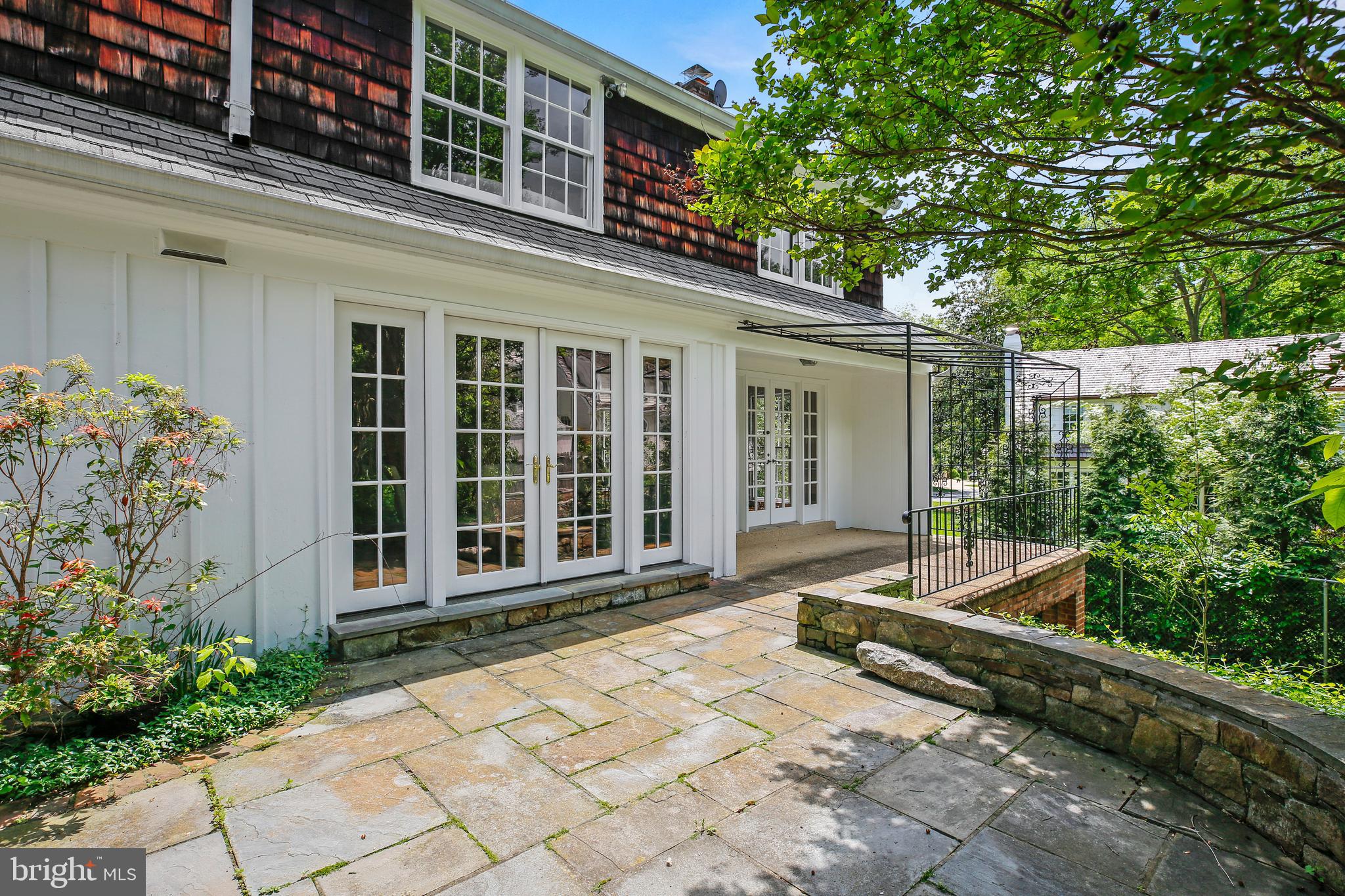 7125 Darby Road Bethesda, MD 20817 - Photo 12 of 64 a view of a house with a large window and flower plants