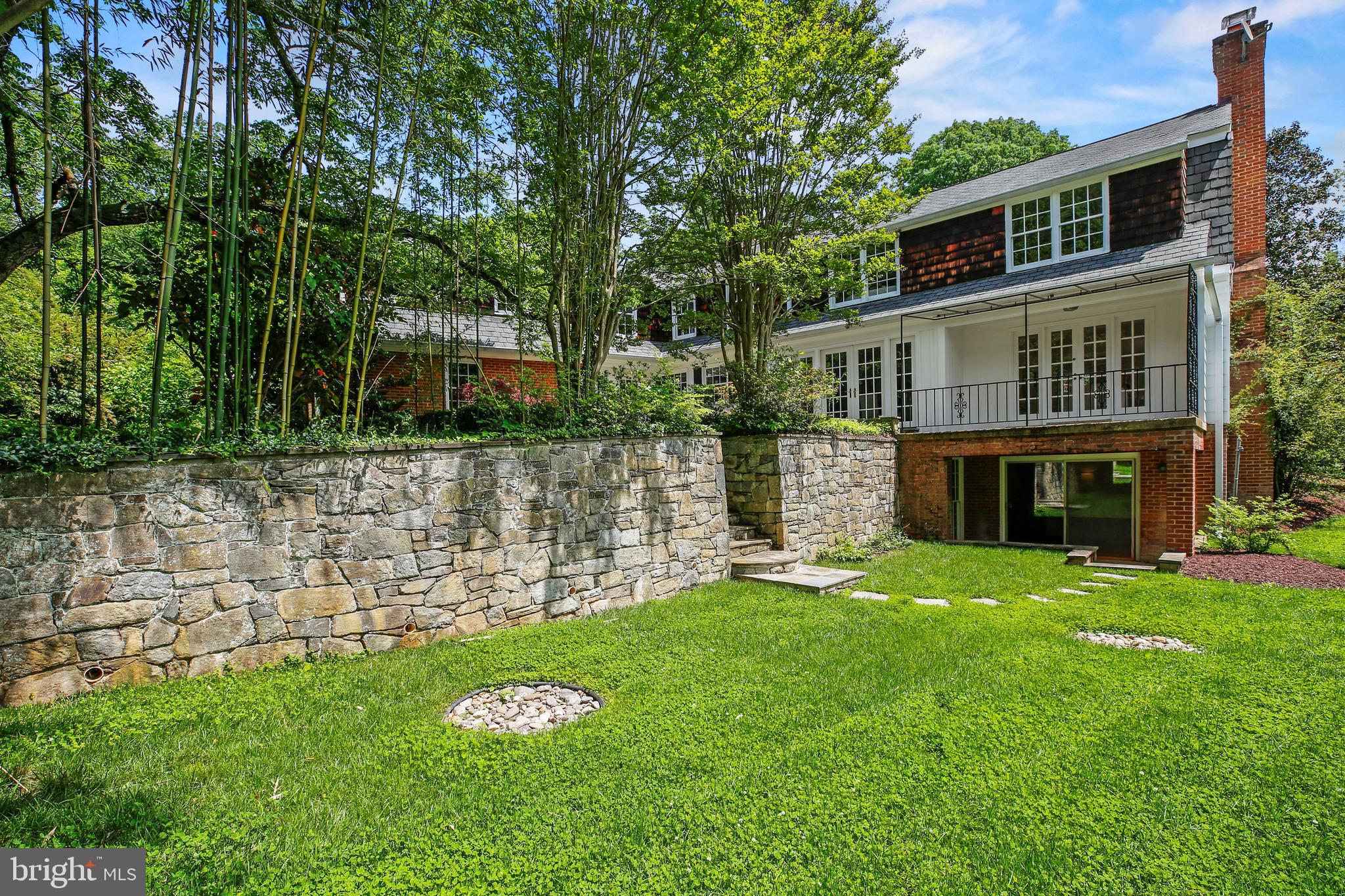 7125 Darby Road Bethesda, MD 20817 - Photo 18 of 64 a front view of a house with a garden