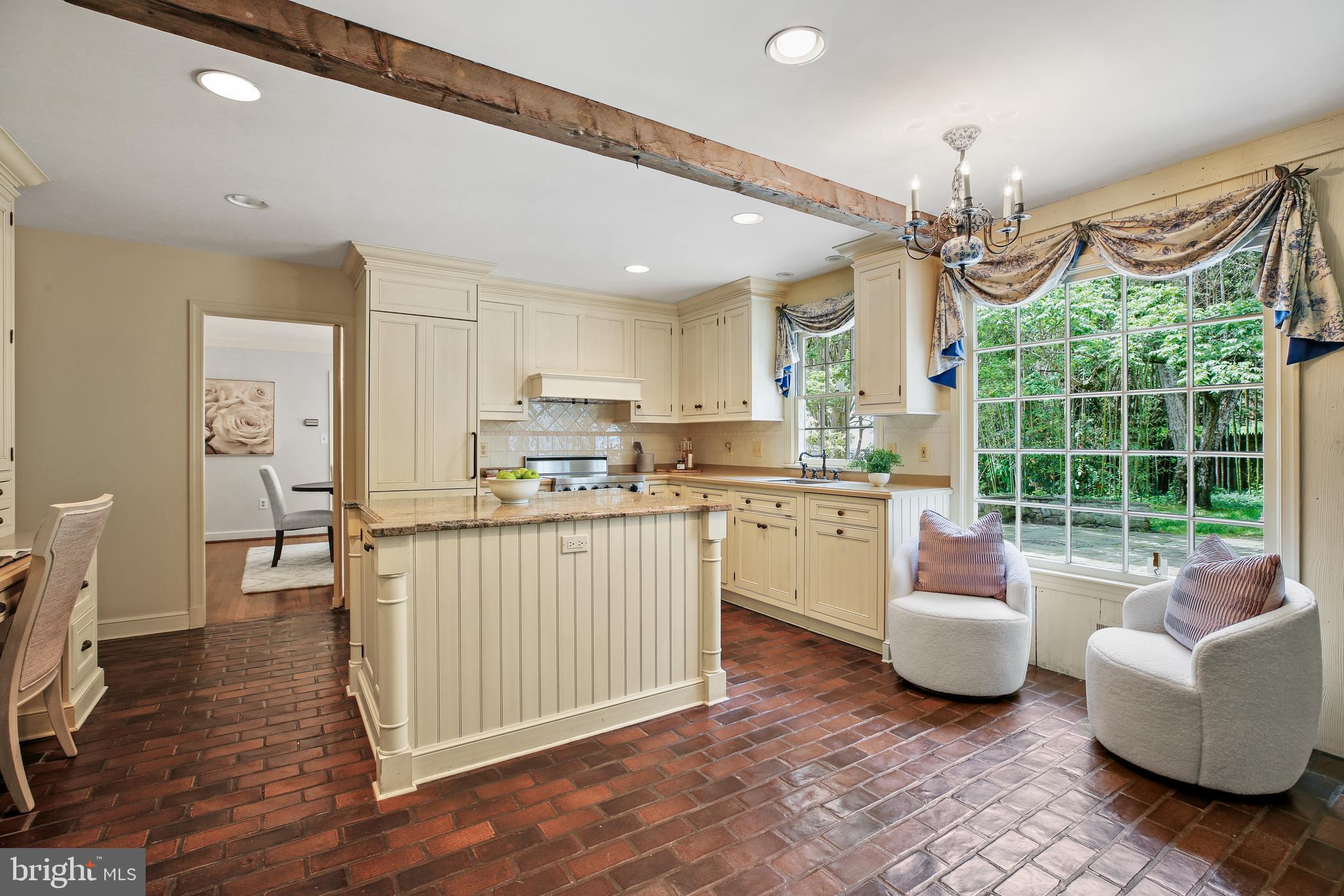 7125 Darby Road Bethesda, MD 20817 - Photo 20 of 64 a kitchen with a refrigerator a sink dishwasher a dining table and chairs with wooden floor