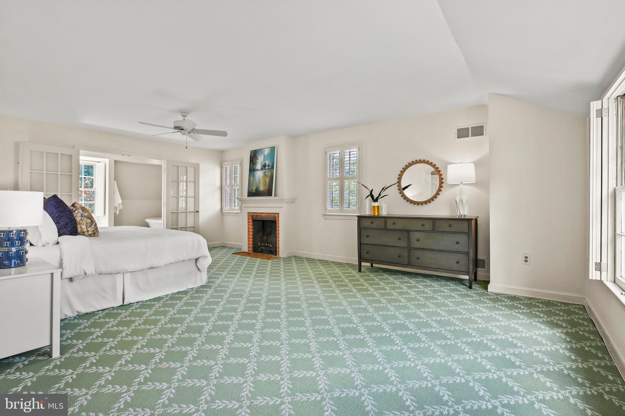 7125 Darby Road Bethesda, MD 20817 - Photo 35 of 64 a spacious bedroom with a bed and a chandelier