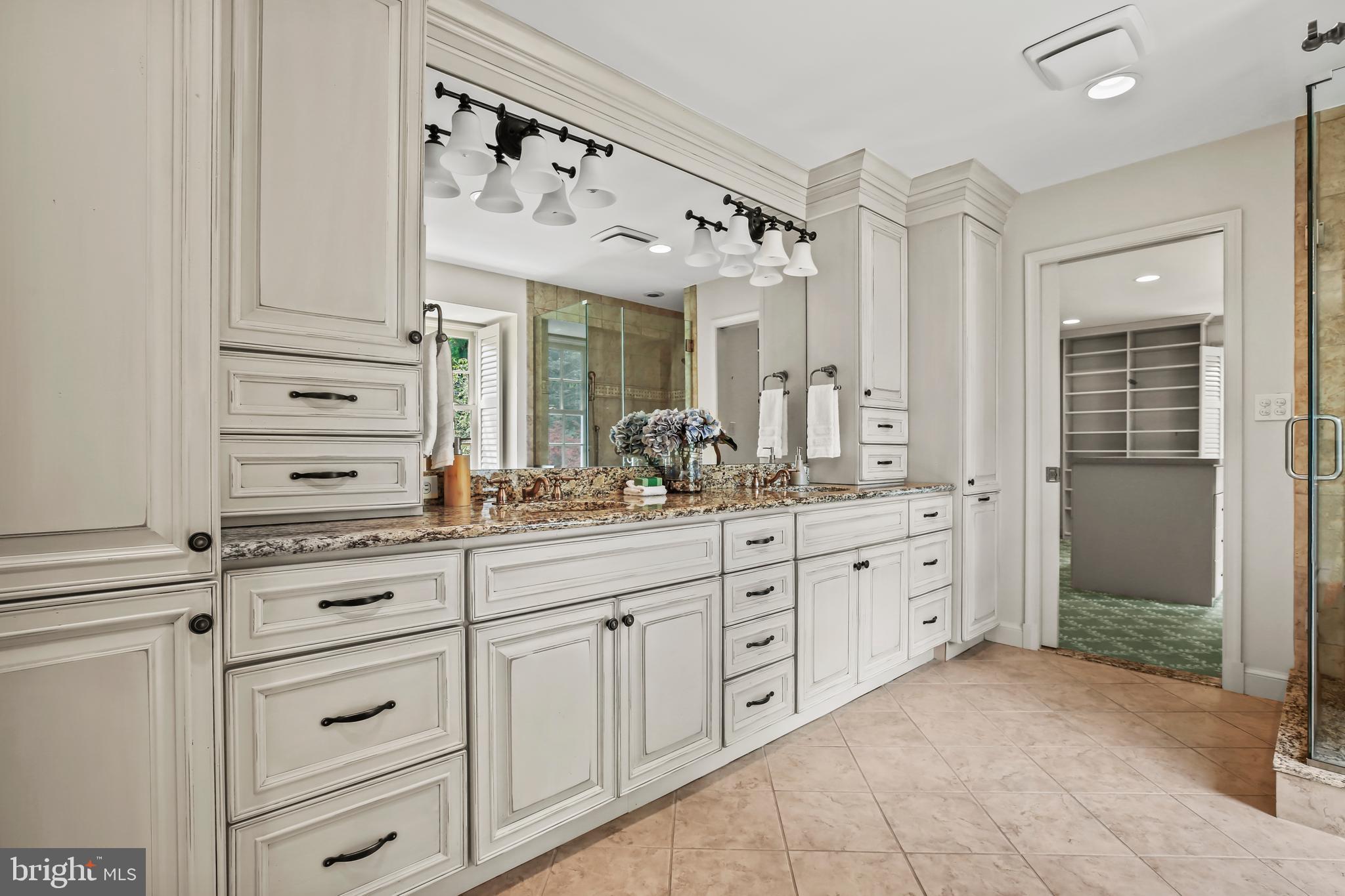 7125 Darby Road Bethesda, MD 20817 - Photo 36 of 64 a bathroom with a granite countertop sink vanity mirror next to a cabinet