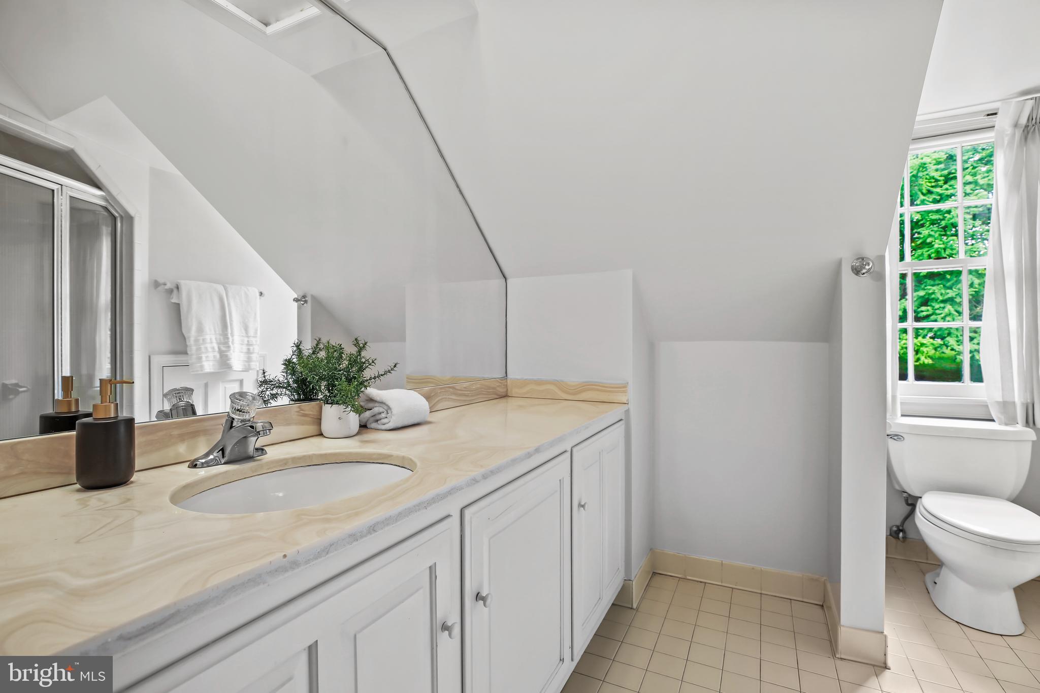 7125 Darby Road Bethesda, MD 20817 - Photo 45 of 64 a bathroom with a granite countertop sink and a mirror