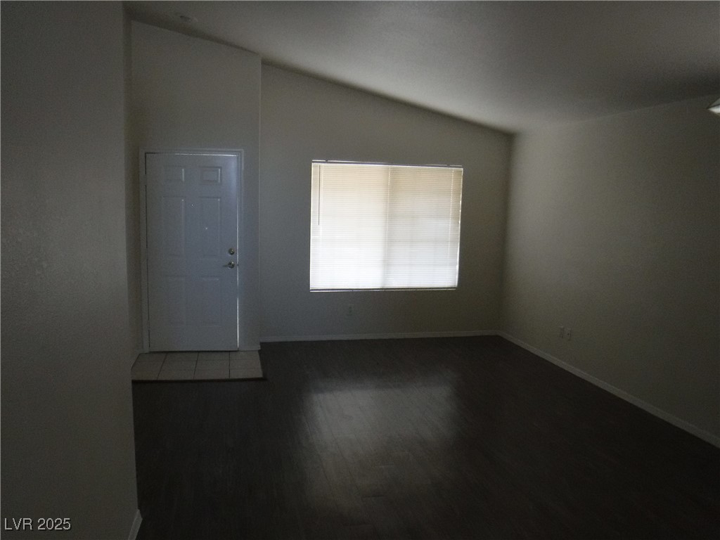 2422 Tottingham Road Henderson, NV 89074 - Photo 7 of 25 Unfurnished room with vaulted ceiling and dark wood-style floors