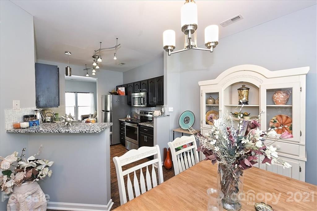 1262 Branson Road Northwest Concord, NC 28027 - Photo 12 of 34 a view of a dining room with furniture and chandelier