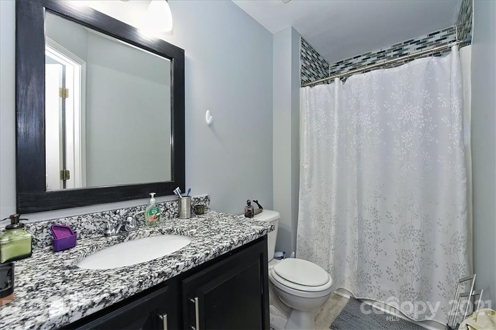 1262 Branson Road Northwest Concord, NC 28027 - Photo 22 of 34 a bathroom with a granite countertop sink and a mirror
