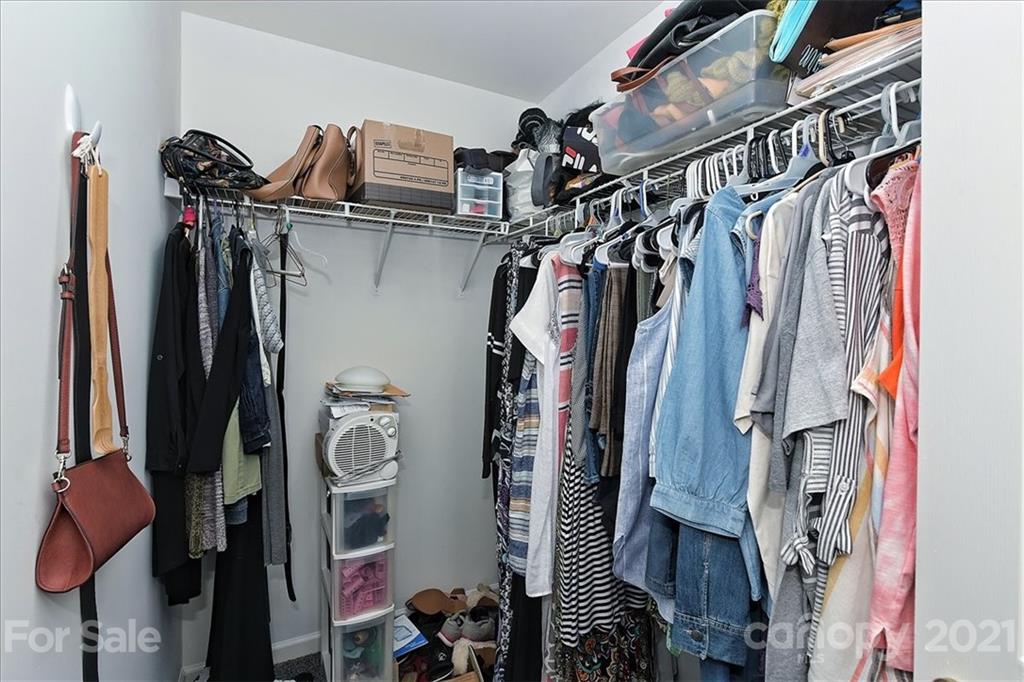 1262 Branson Road Northwest Concord, NC 28027 - Photo 23 of 34 a view of walk in closet with clothes and shoes