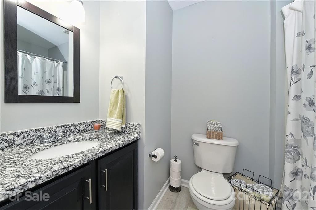 1262 Branson Road Northwest Concord, NC 28027 - Photo 25 of 34 a bathroom with a granite countertop toilet sink and mirror