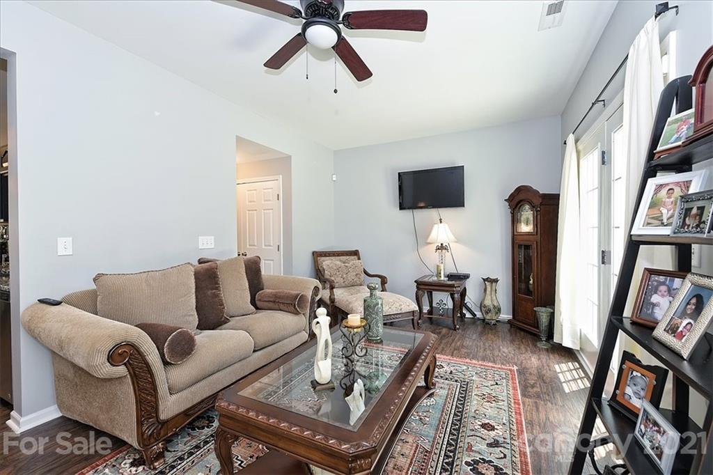 1262 Branson Road Northwest Concord, NC 28027 - Photo 8 of 34 a living room with furniture and a flat screen tv