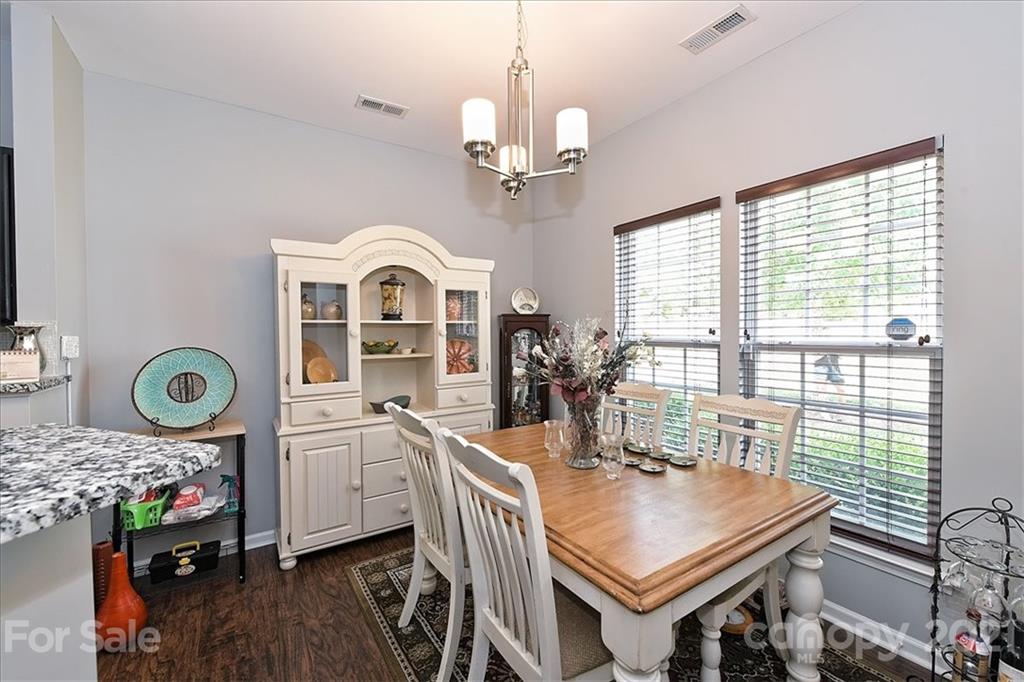 1262 Branson Road Northwest Concord, NC 28027 - Photo 10 of 34 a view of a dining room with furniture a chandelier and a window