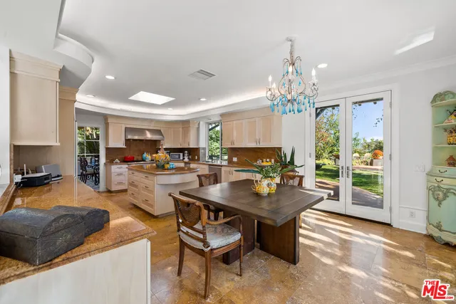 a room with fireplace furniture and a chandelier