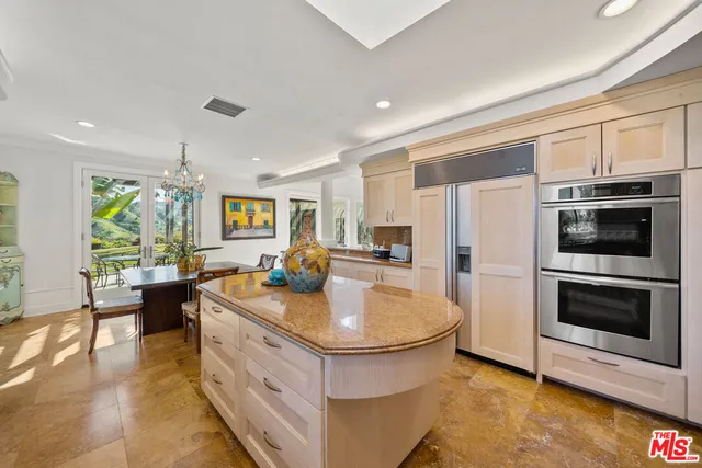 a kitchen with sink stove and refrigerator